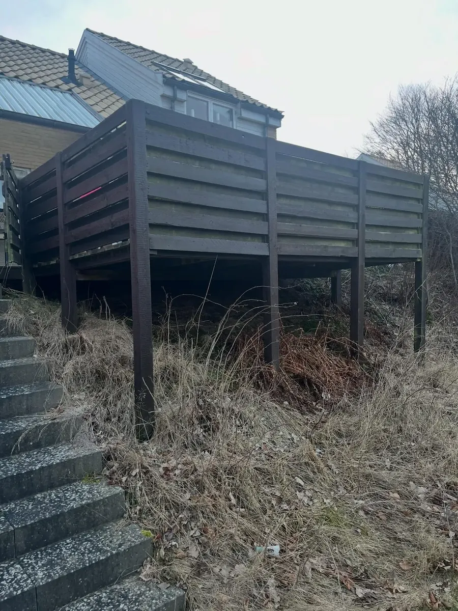 Hævet terrasse før: mørk og nedslidt beklædning
